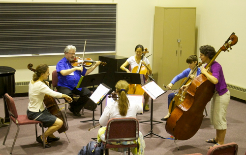 Stephanie Vial, left, working on continuo lines with violas and cellos at the Institute for Early Music on Modern Instruments. (Marion Meakem Photography)