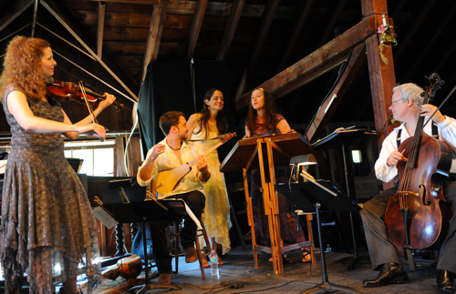 Apollo's Fire members perform a Countryside Concert in a barn.