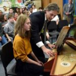 Aymeric Dupré la Tour coaches eigth-grade harpsichord student Addie Clark.
