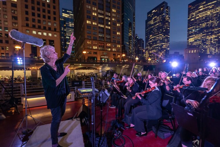 MOB_9.18.24_by_ElliotMandel-Glover-conducts-on-boat.jpg
